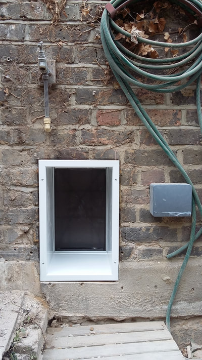 Large dog flap fitted in wall