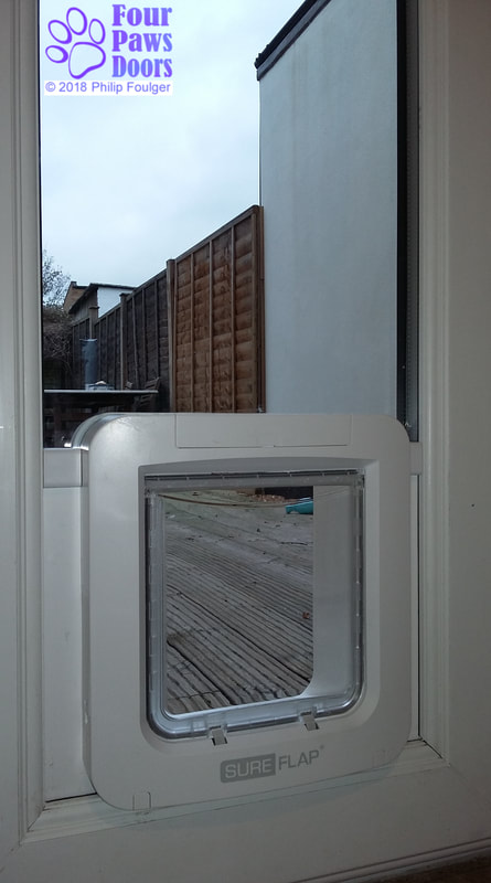 Pet door installed in narrow glazing